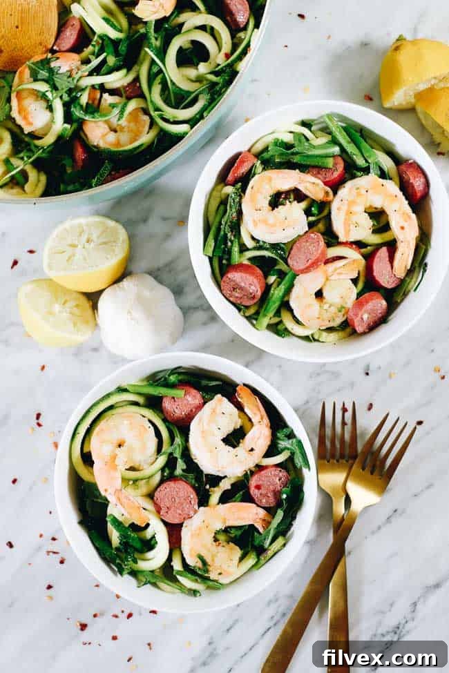 Lemon Garlic Shrimp Pasta in two bowls and a skillet. Lemon and garlic garnish. 