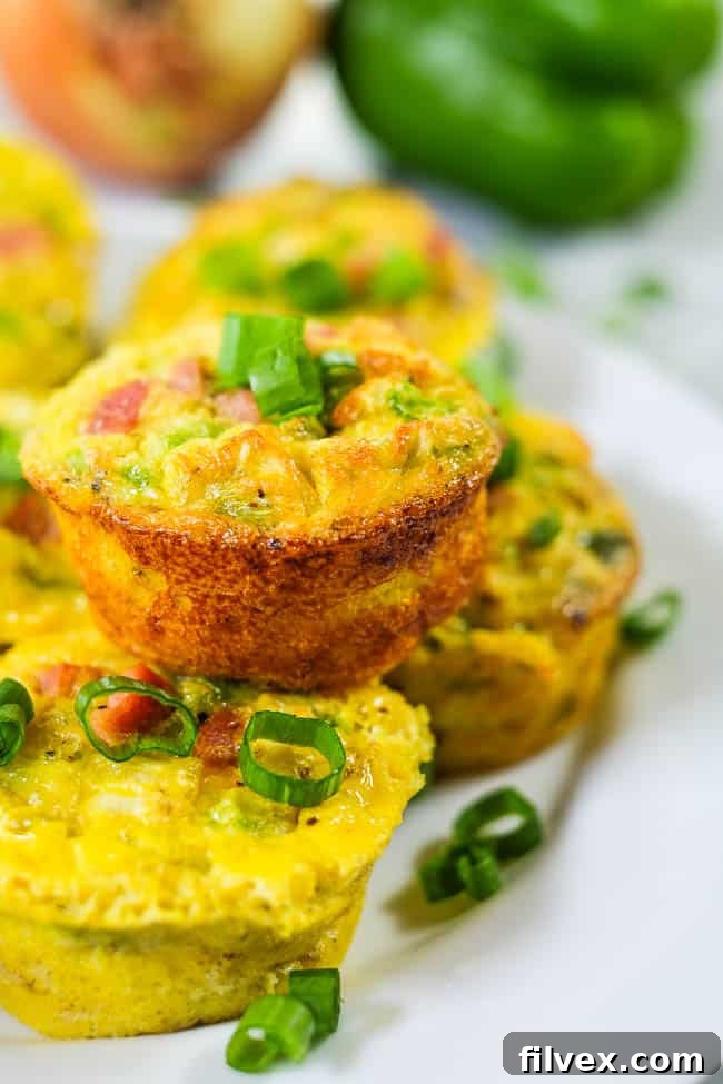 Healthy egg muffins on a plate chopped green onion.