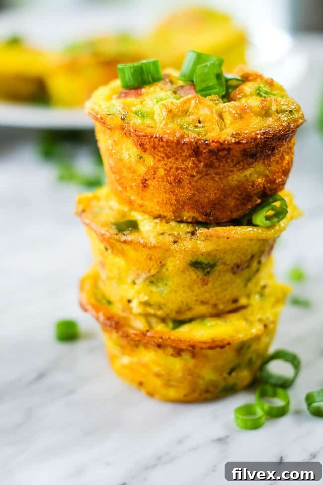 Healthy egg muffins stacked with chopped green onion. 