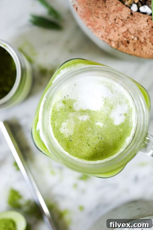Iced matcha latte in a mason jar mug with straw. 