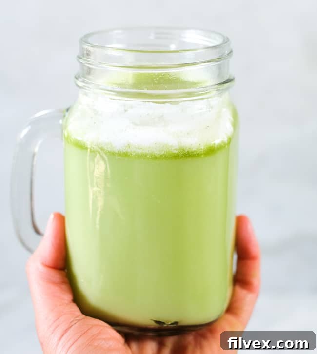 Iced matcha latte in a mason jar mug.