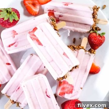 Close-up of a creamy strawberry popsicle, showcasing its rich texture and natural color.