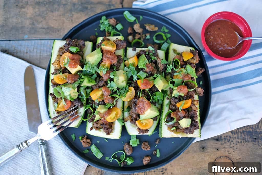 Taco Zucchini boats, filled with seasoned ground beef and fresh toppings.