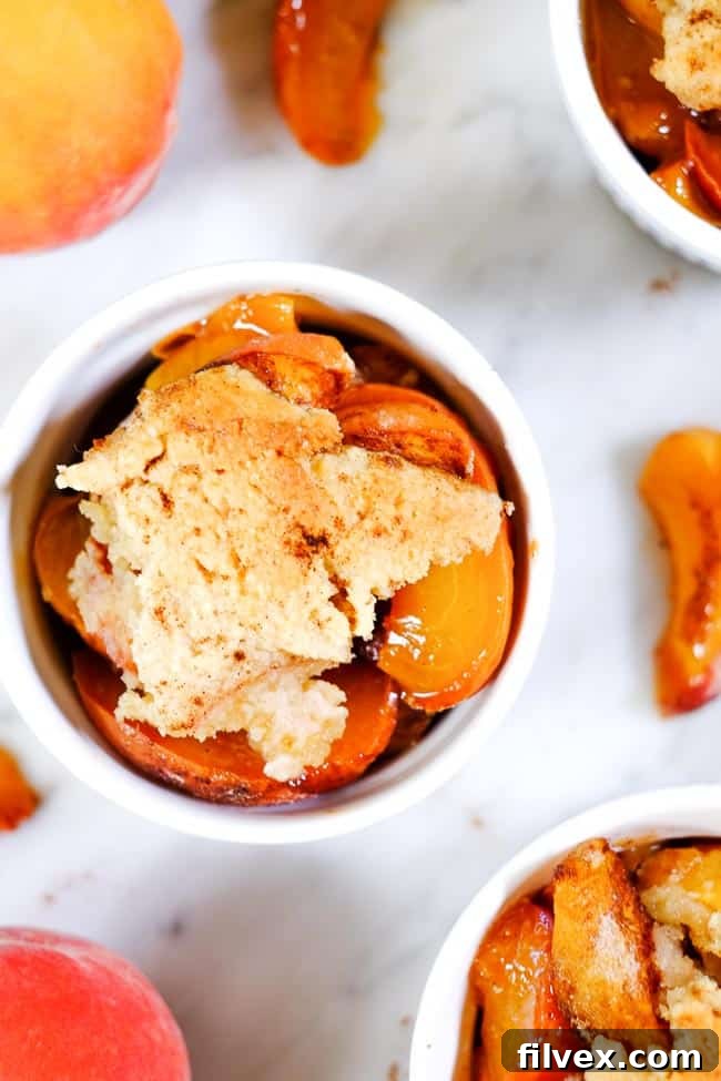 Gluten free peach cobbler in ramekins with extra peaches. 