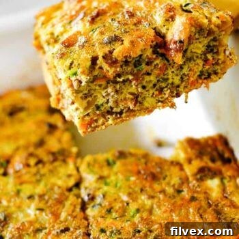 Image of lifting a slice of a loaded breakfast casserole out of the pan.