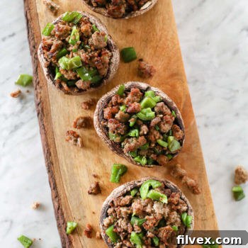 Sausage-stuffed portobello mushrooms, overhead view.