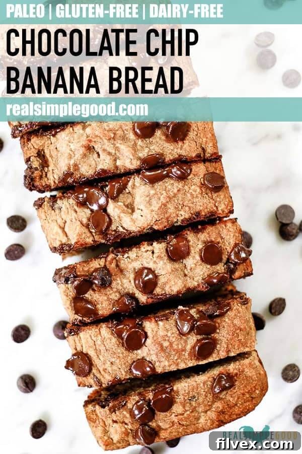 Long shot of a sliced Paleo chocolate chip banana bread loaf on a wooden table, emphasizing its perfect texture and rich chocolate distribution.