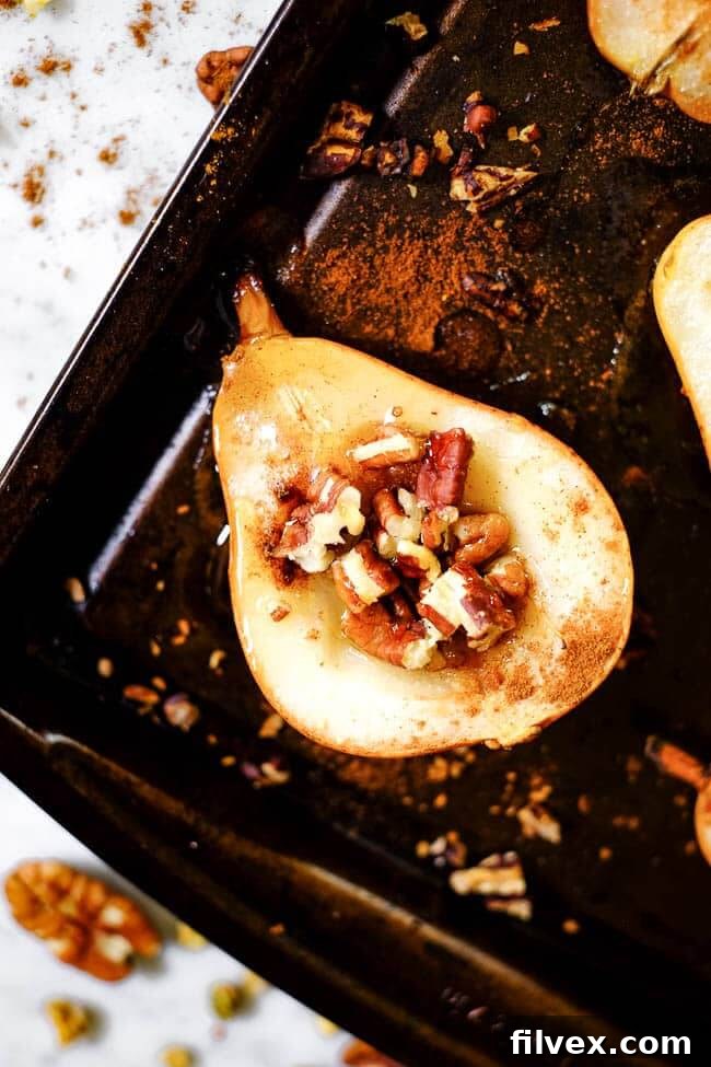 Easy baked pears on a cookie sheet with cinnamon, chopped nuts and honey. 