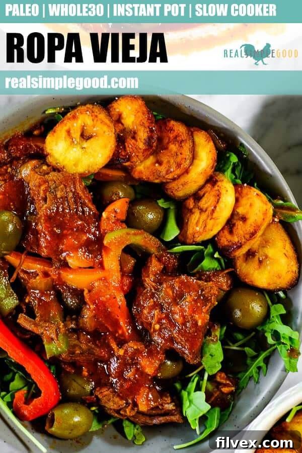Close up shot of Ropa Vieja served in a bowl with greens and fried plantains, ready to be shared on Pinterest as a long pin.