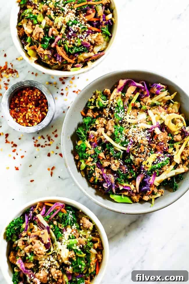 Egg roll in a bowl in three bowls. Made with cruciferous veggies, ground pork and a savory sauce. 