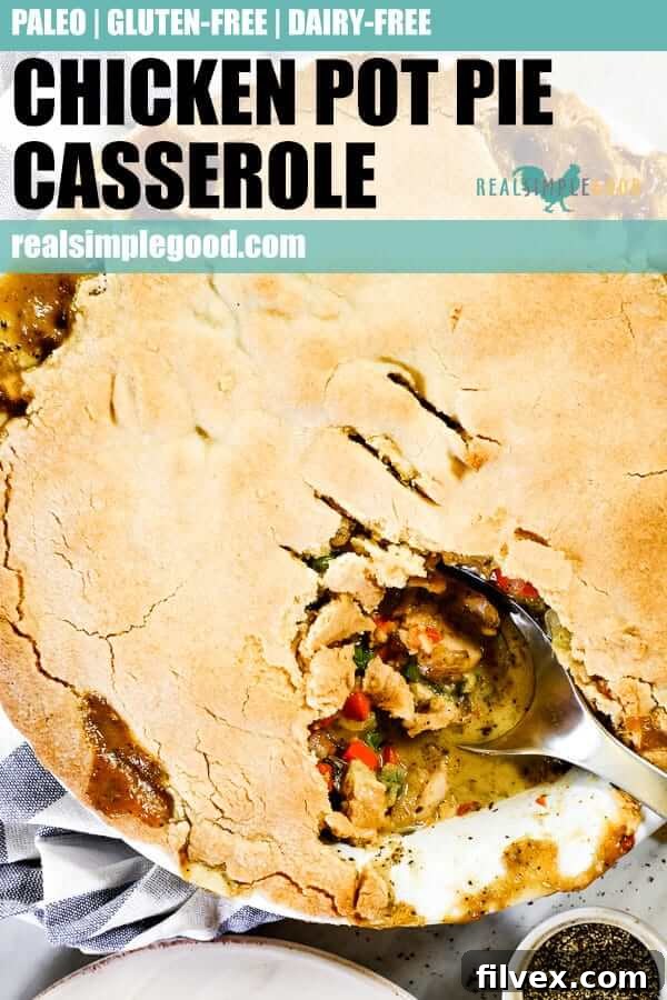 Close up shot of dairy-free chicken pot pie casserole in a baking dish with a serving spoon, suitable for a long Pinterest pin.