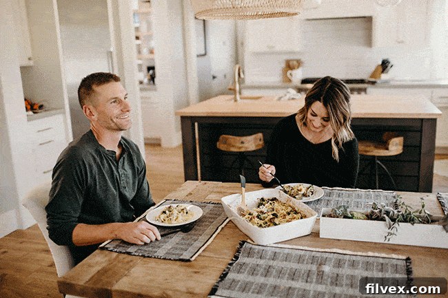 Man and woman happily eating together at a table, symbolizing the return to normal after a 'hangry' episode.