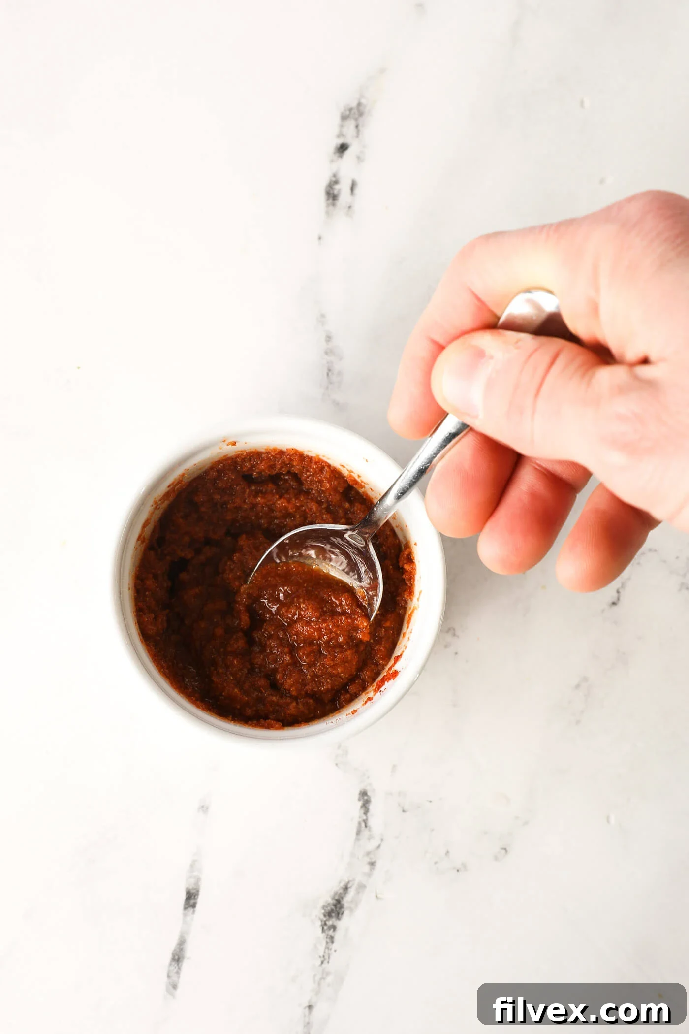 Mixing the flavorful sauce ingredients in a bowl