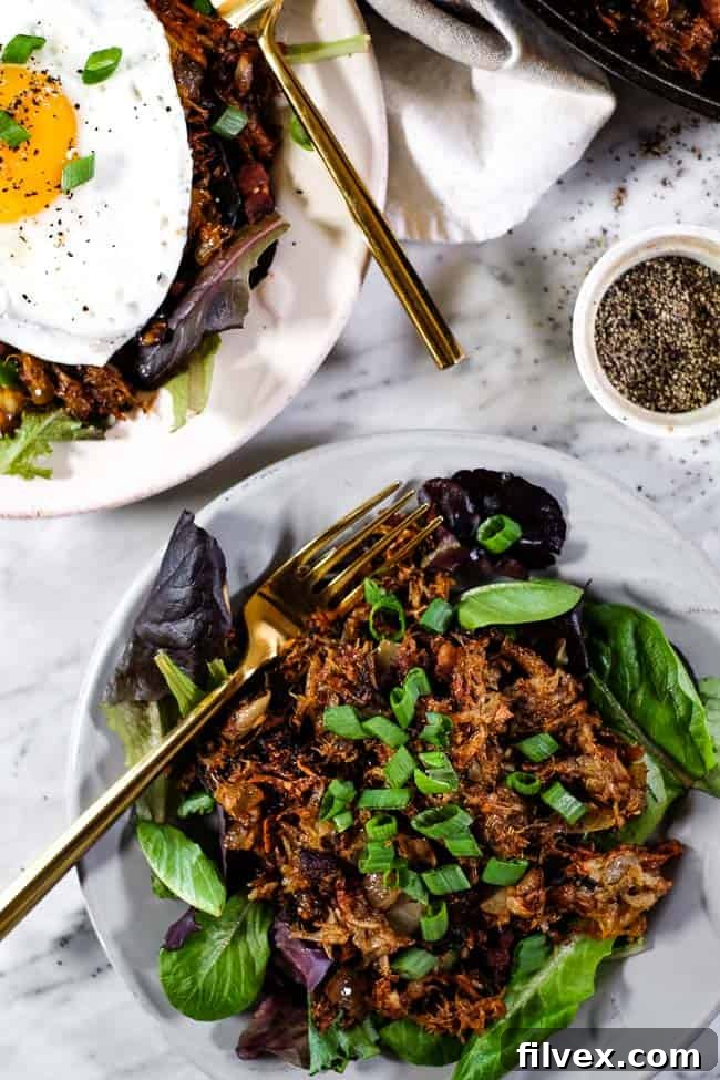 Two plates of Leftover Pulled Pork Hash garnished with vibrant green onions, showcasing a delicious and appealing meal.