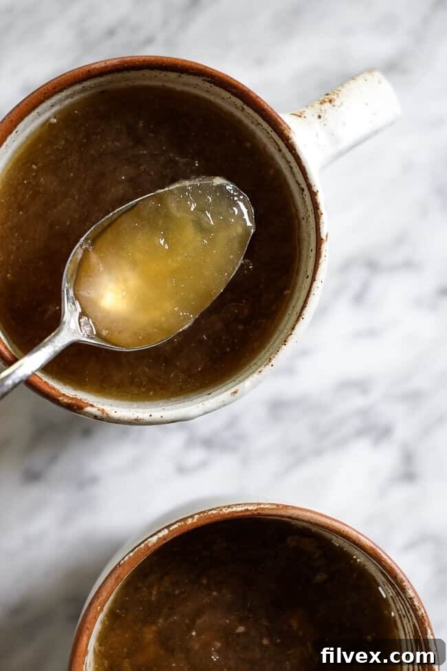 Two mugs of bone broth. Blog post about where to buy bone broth and why you should add it to your diet. 