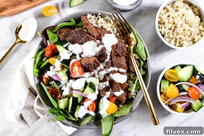 Beef shawarma bowl with seasoned beef, greens, cauliflower rice, cucumber, tomato, red onion and a dairy free tzatziki sauce. A complete Paleo, Whole30, and Keto meal.