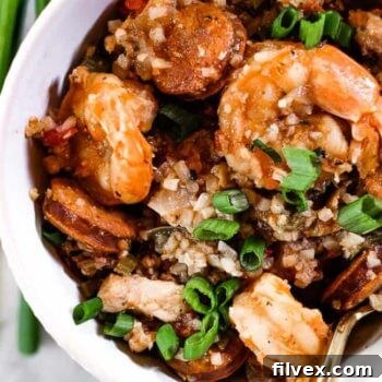 Close up of Instant Pot Jambalaya served in a bowl with chopped green onion garnish.