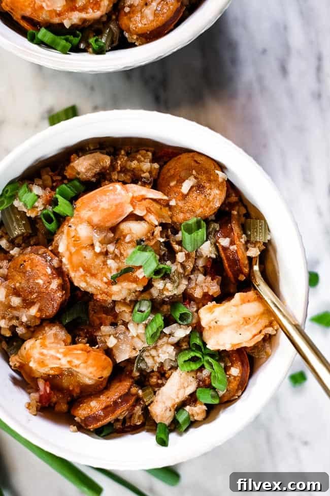 Instant Pot Jambalaya served in two rustic bowls, garnished with chopped green onions, ready to be enjoyed.