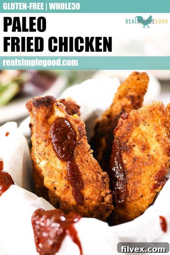 Paleo fried chicken like fries in a mug with parchment paper and drizzled BBQ sauce. 