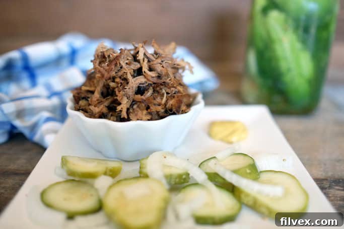 A serving of Crockpot Pulled Pork with a side of vegetables.