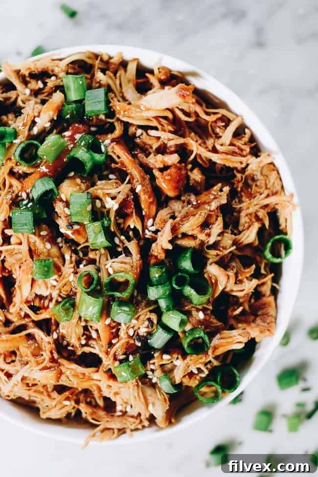 Slow Cooker Teriyaki Chicken served with broccoli and sesame seeds.