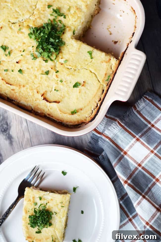 Turkey, broccoli and mashed cauliflower layered casserole overhead shot with piece on plate