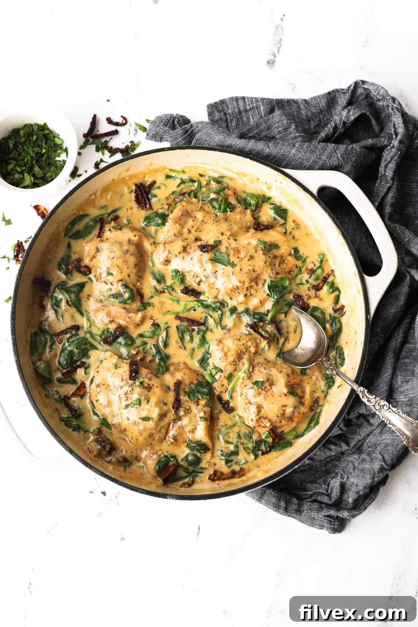 A close-up of the creamy Tuscan chicken sauce, highlighting the texture and ingredients.