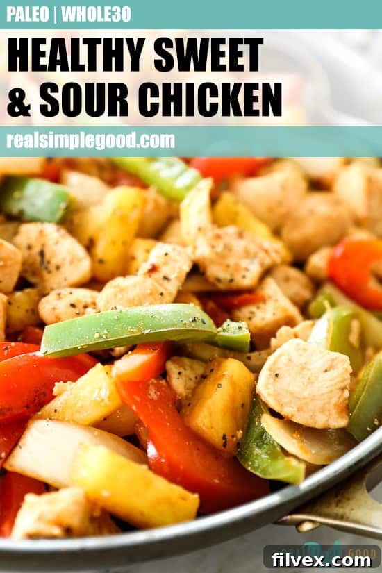Angled shot of sweet and sour chicken in skillet with text at the top of the photo for pinterest. Dish includes chicken, onion, red and green bell pepper, pineapple and a sweet and sour sauce. 