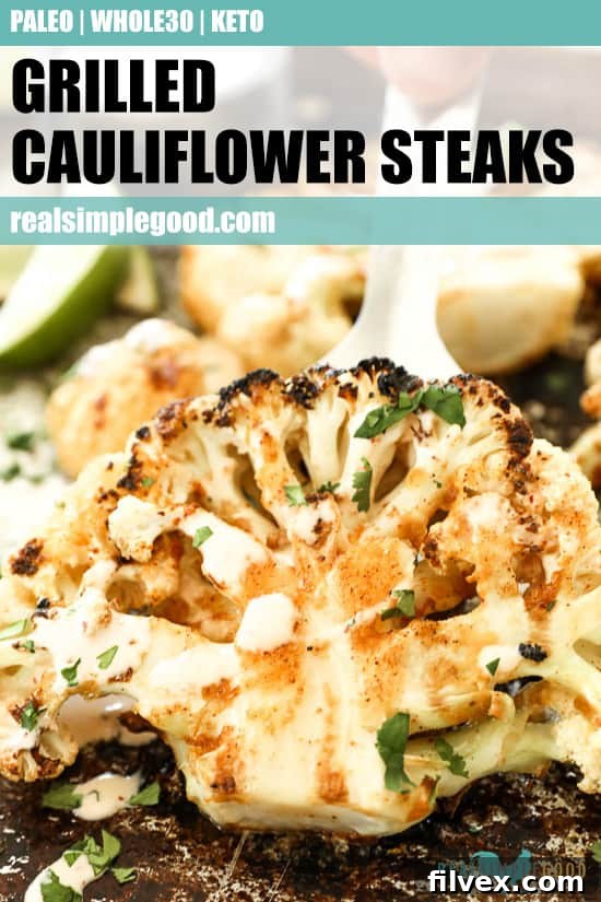 Close up of lifting cauliflower steak off pan with text overlay at top for pinterest. 