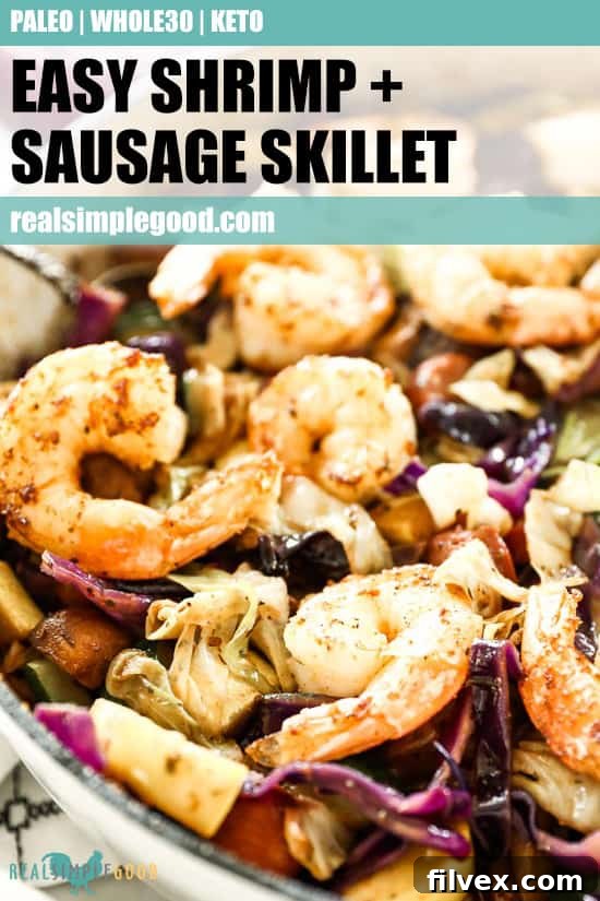 Close up of sausage and shrimp in skillet with other veggies and text overlay at top for pinterest.