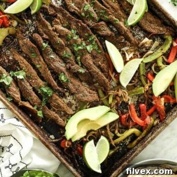 Sheet pan fajitas with steak, bell peppers, and onion