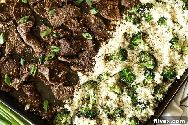 Sesame beef with cauliflower rice and broccoli on a sheet pan, ready to be served. 