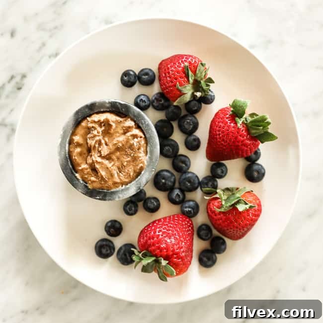 Strawberries and blueberries on a plate with almond butter