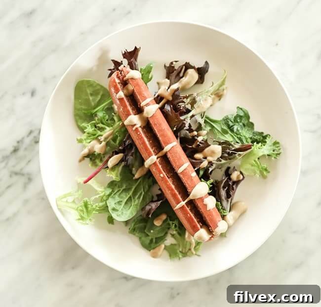 Greens with hot dot and mustard drizzle on top on a plate