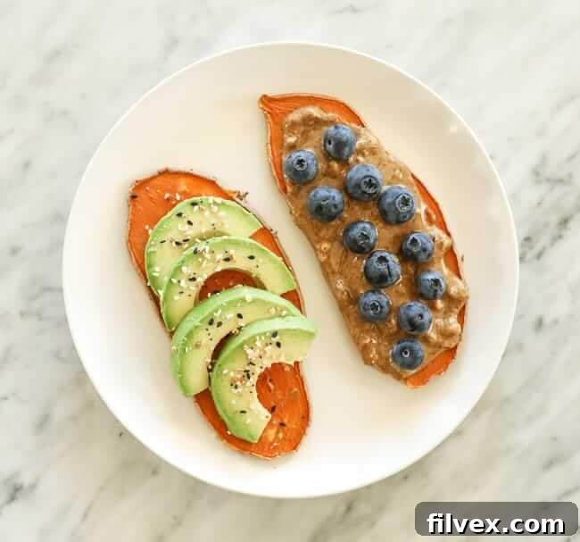 Sweet potato toast with avocado and nut butter and berry topping on a plate