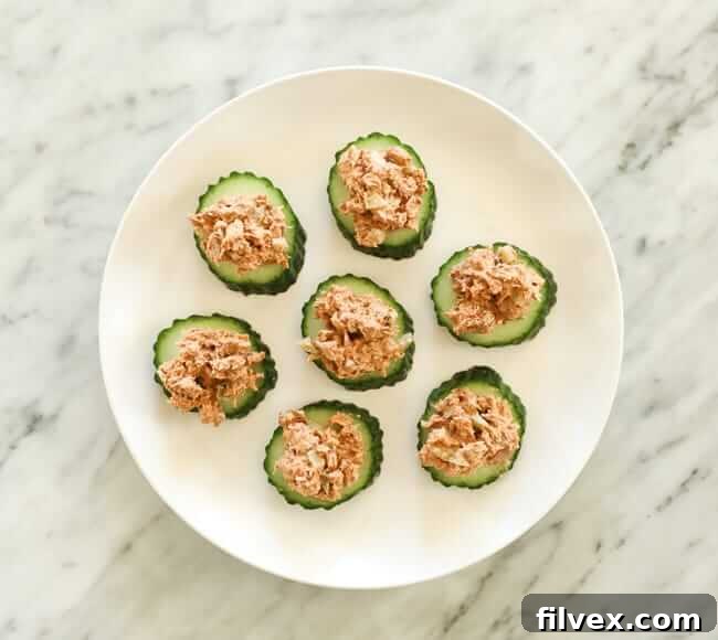 cucumber slices topped with tuna on a plate