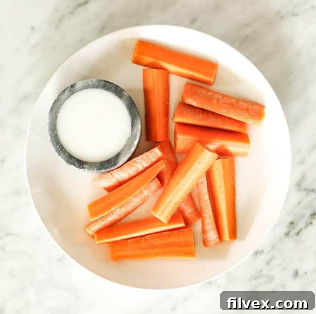 Sliced carrots with coconut butter on a plate