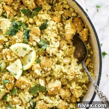 Overhead shot of Indian chicken with cauliflower rice in a pan, ready to serve.
