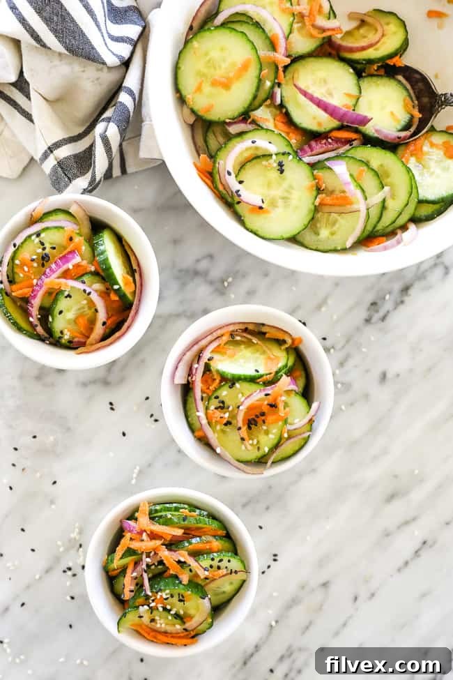 Asian cucumber salad in 3 ramekins with bowl at top