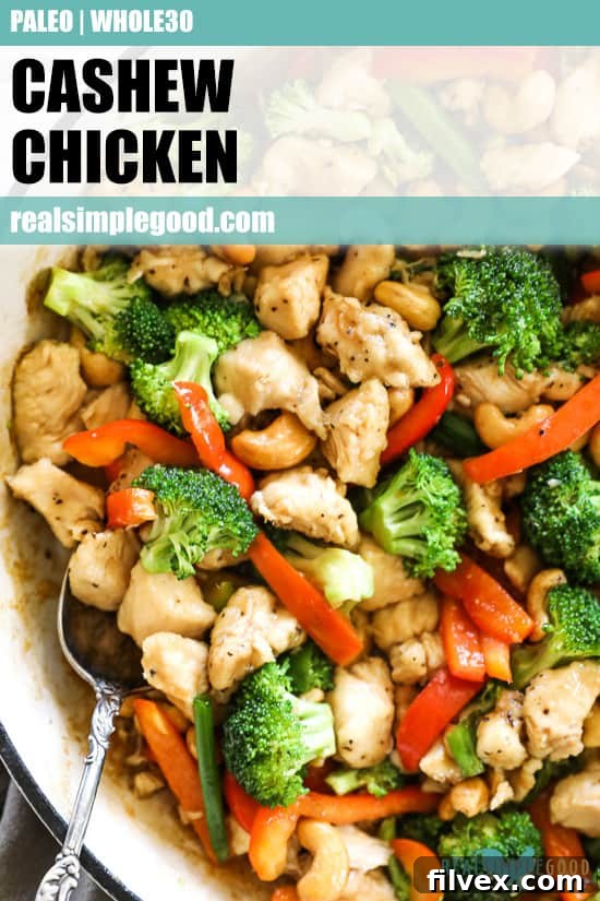 Overhead close up image of cashew chicken in a skillet with a serving spoon and text overlay at top for pinterest.