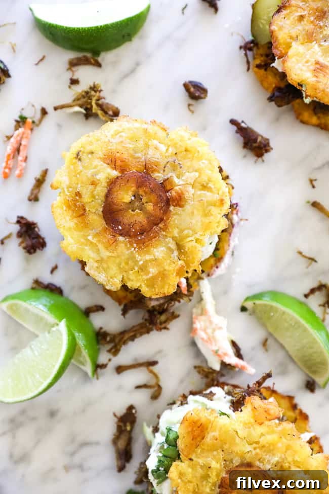 Overhead shot of jibarito recipe with smashed plantain on top. 