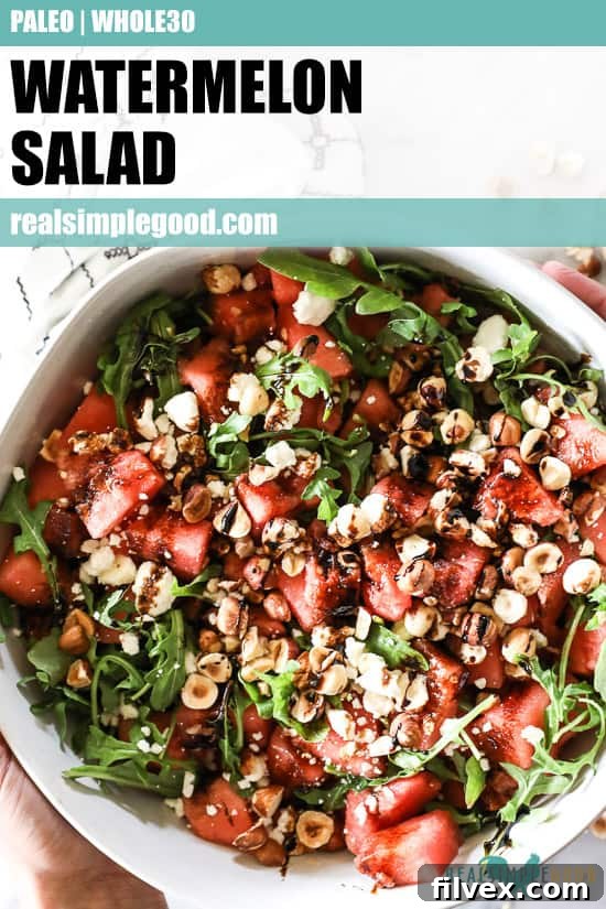 Overhead vertical image of a generous serving of watermelon salad in a large bowl, with a text overlay for Pinterest promoting the healthy summer side dish.