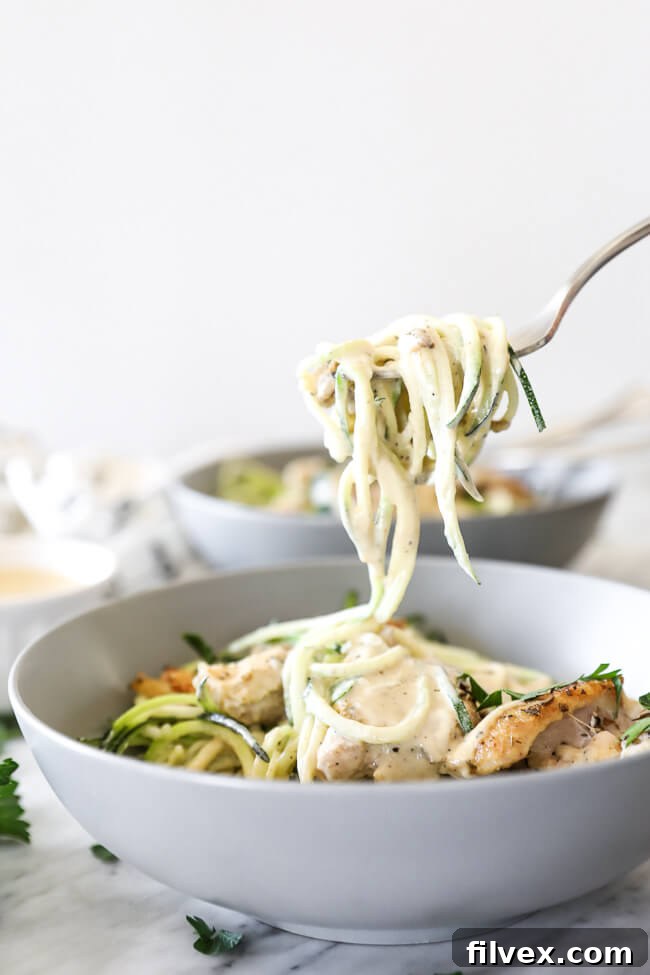 Creamy chicken alfredo dish with fresh parsley garnish.