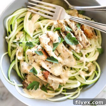 Creamy chicken alfredo with zoodles and spoon and fork