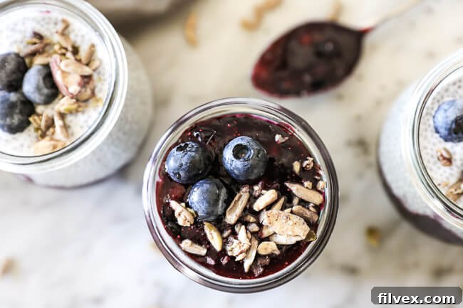 Paleo chia seed pudding horizontal overhead shot with 3 jars and spoon