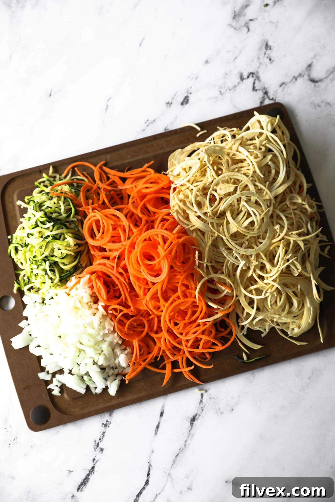 Spiralize the potatoes and dice the onion. Transfer everything to a casserole dish.