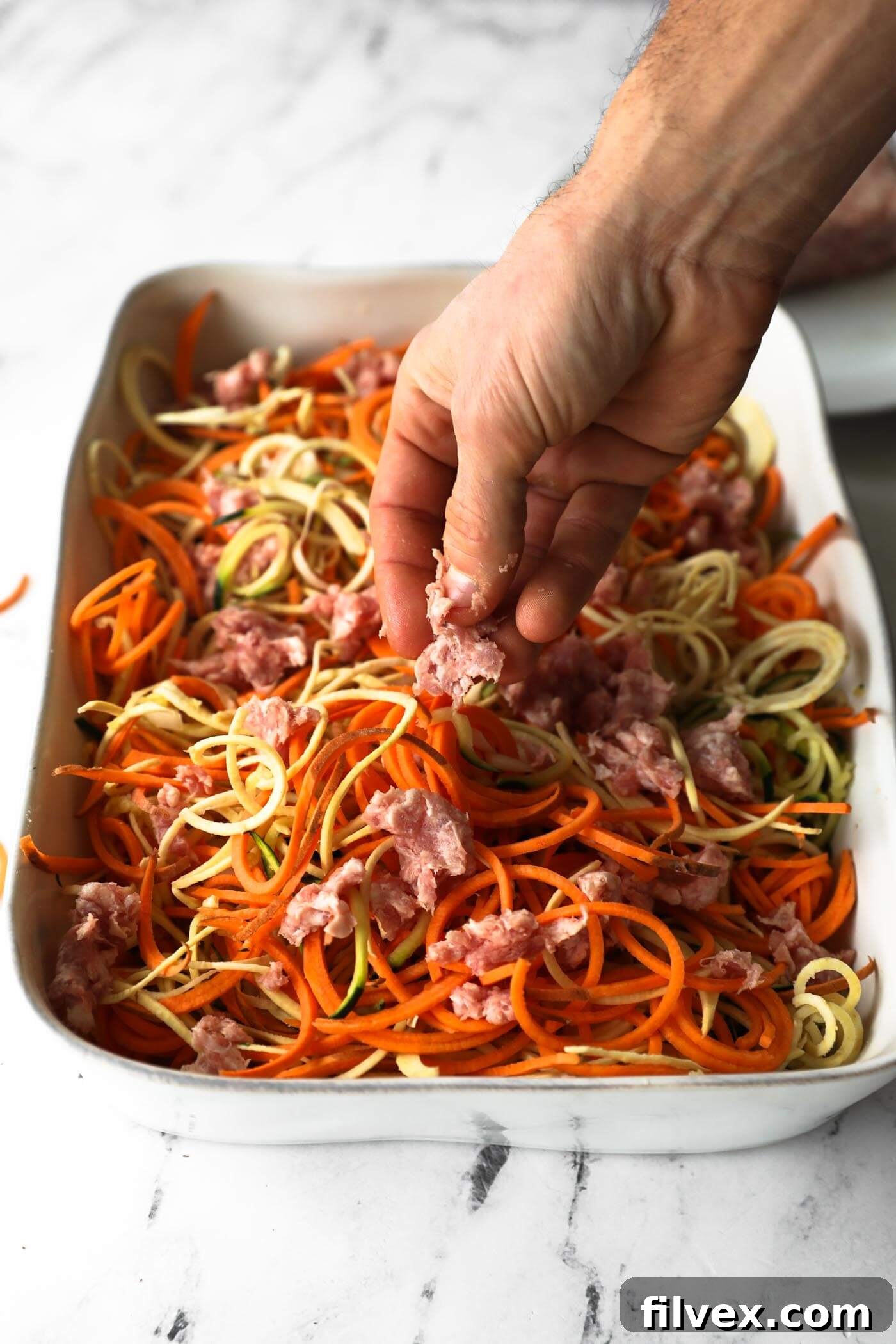 Break the ground pork into bits and nestle the pieces in with the noodles. Transfer to the oven to cook at 400° F for 40-50 minutes.