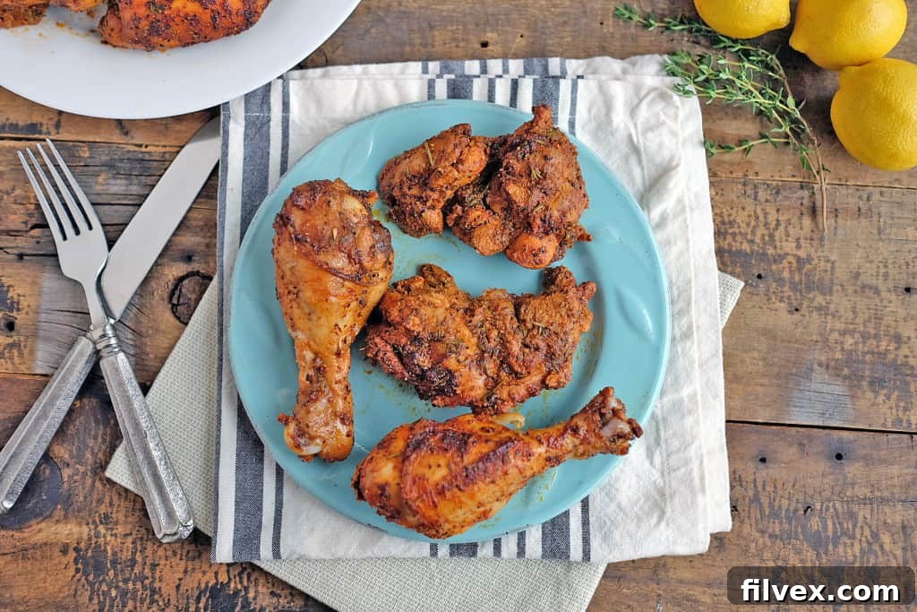 Lemon Thyme Chicken pieces marinating in a clear plastic bag with fresh lemon and thyme.