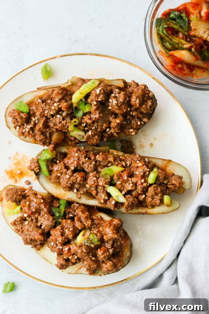 Sloppy joes stuffed in potatoes that are cut in half and topped with sliced green onion, a creative and hearty serving suggestion.