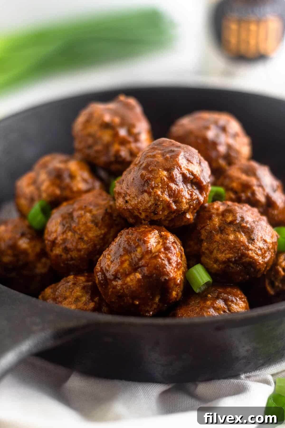 Instant Pot BBQ chicken meatballs in a skillet, showcasing their delicious glaze and texture.